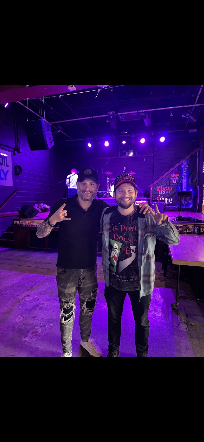 Jordon Frank and Andrew Isler posing together at a live music venue